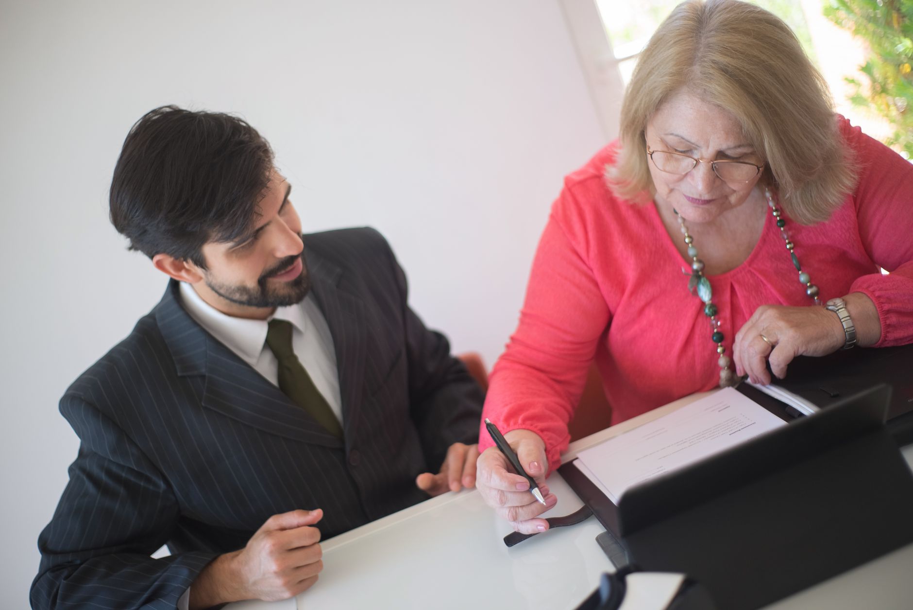Friendly lawyer answering questions for elderly client